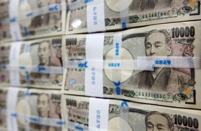 Japanese yen notes are piled up after counting at a bank during a photo opportunity in Seoul